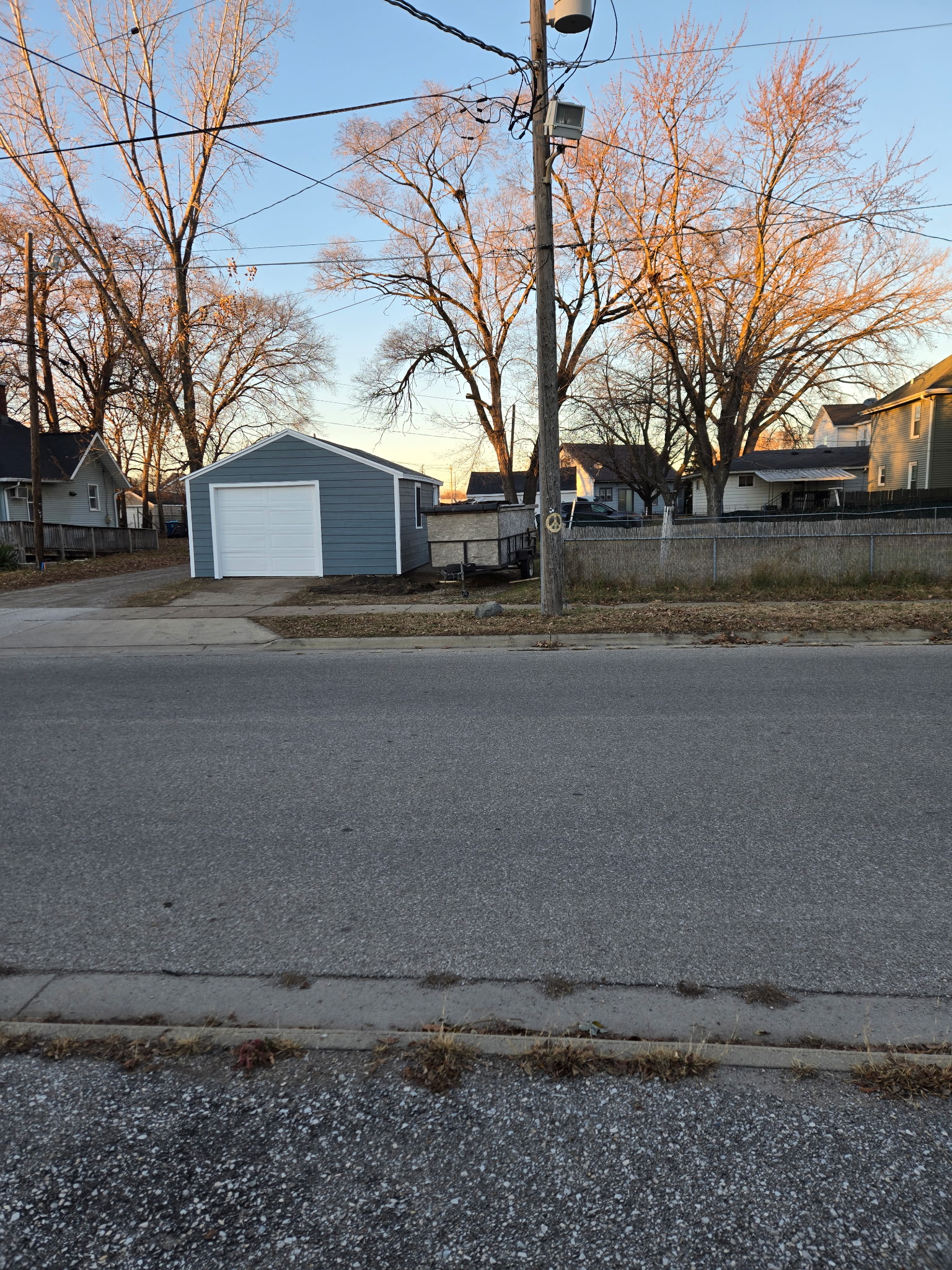 Residential exterior painting - blue-grey house with white garage door